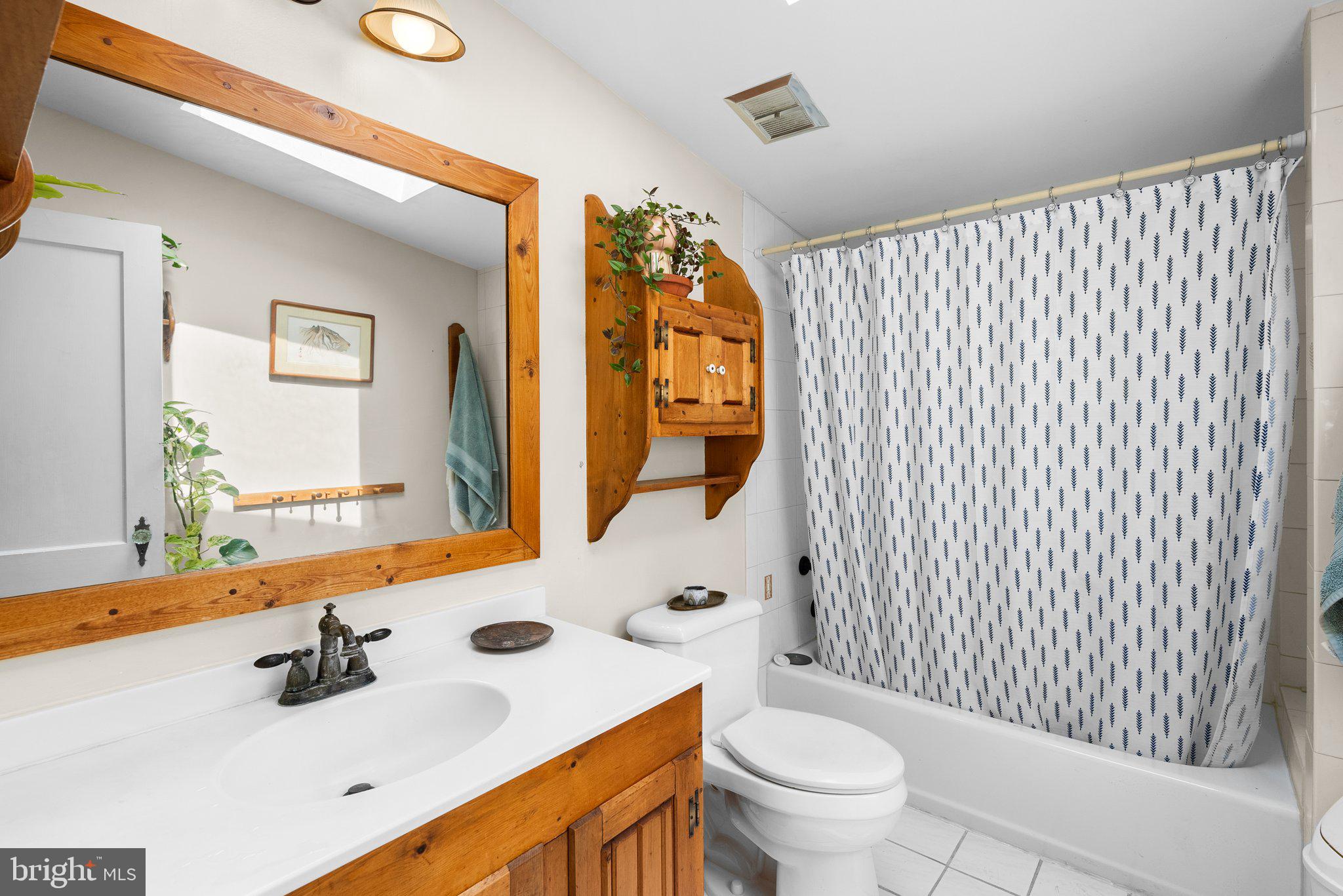 13321 Travilah Road Potomac, MD 20854 - Photo 34 of 43 a bathroom with a sink vanity mirror and toilet