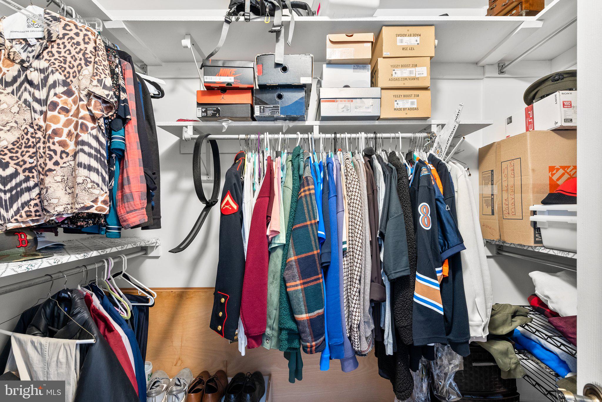 13321 Travilah Road Potomac, MD 20854 - Photo 35 of 43 a view of walk in closet with clothes and shoes