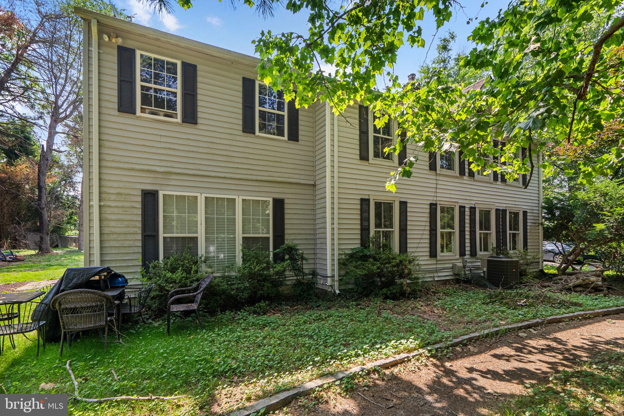 13321 Travilah Road Potomac, MD 20854 - Photo 43 of 43 a backyard of a house with a garden and barbeque oven