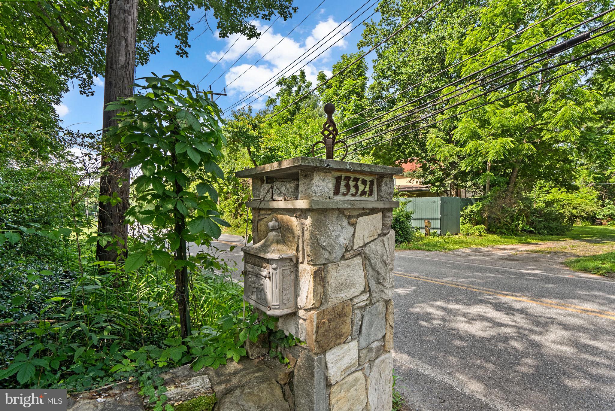 13321 Travilah Road Potomac, MD 20854 - Photo 5 of 43 a sign board with tall trees