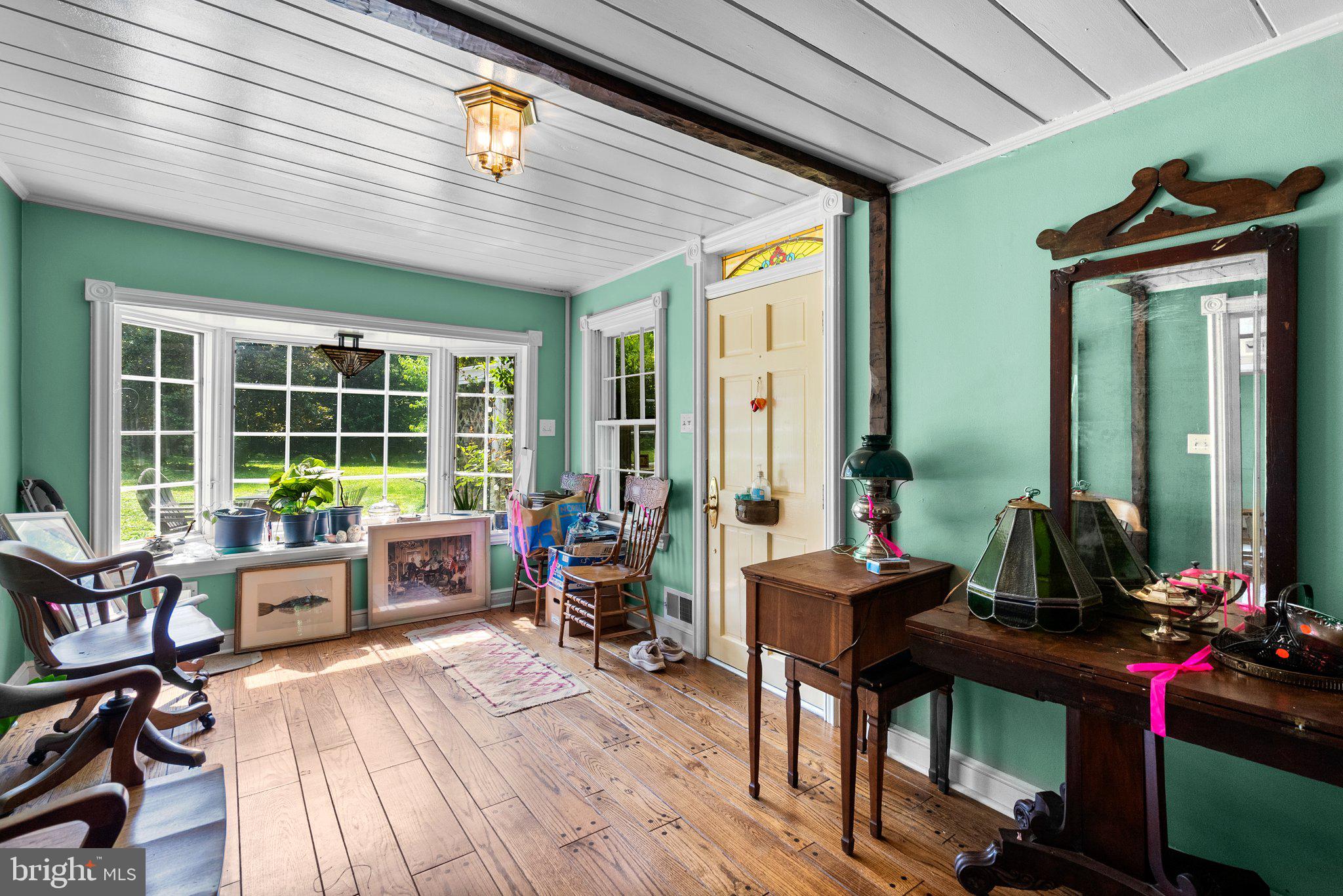 13321 Travilah Road Potomac, MD 20854 - Photo 7 of 43 a living room filled with furniture and floor to ceiling windows