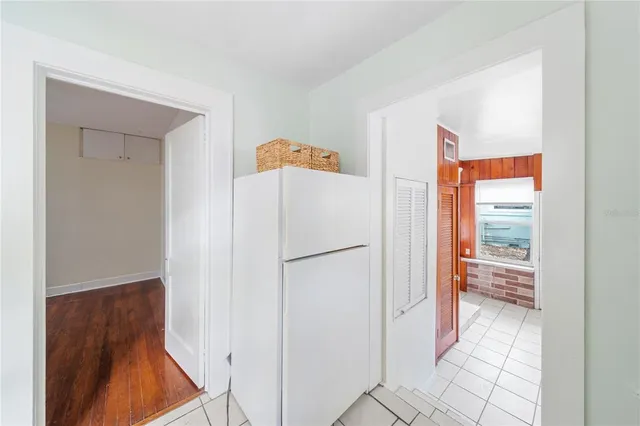 a white refrigerator freezer and a stove sitting inside of a kitchen