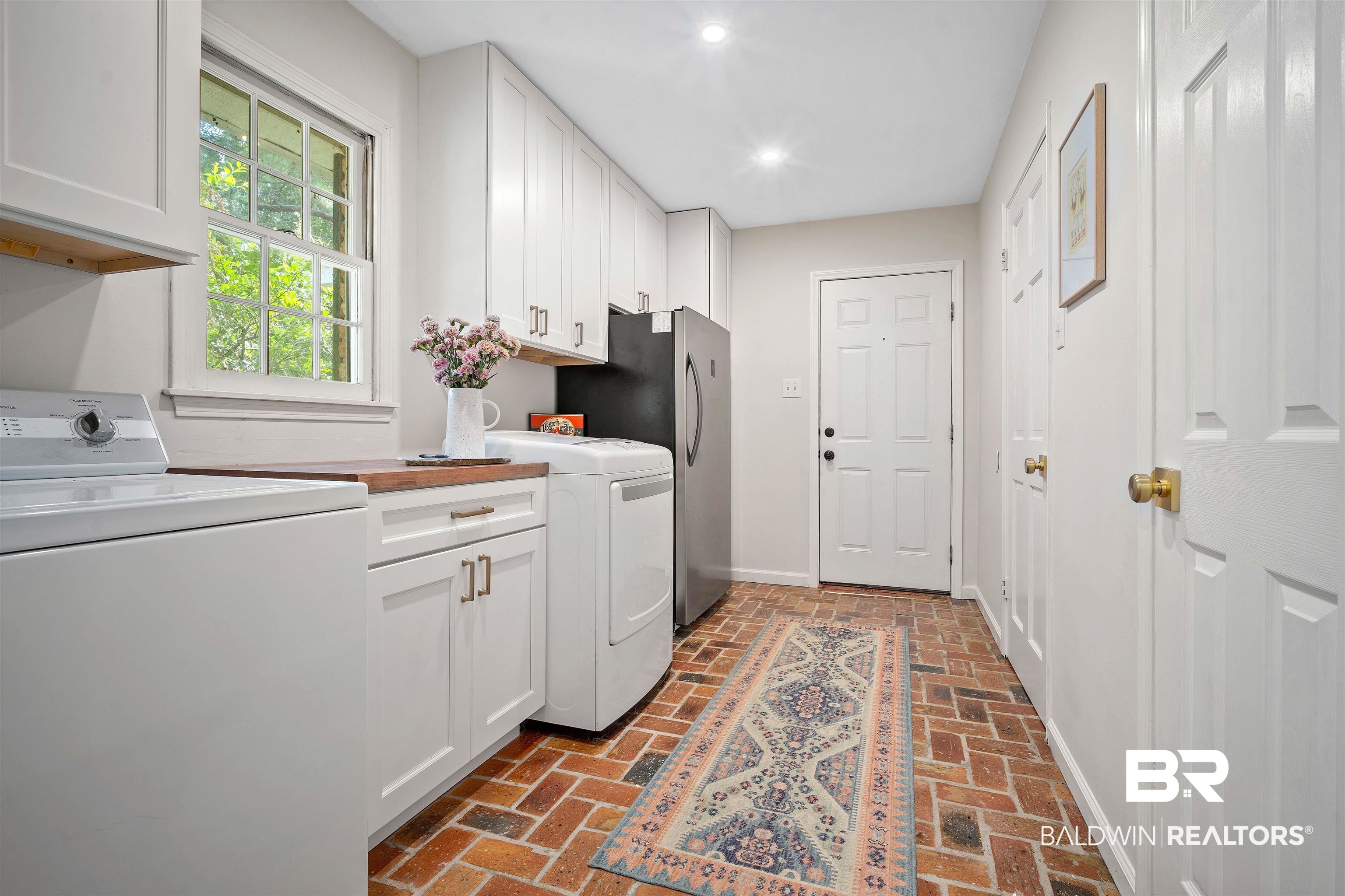 700 Eliza Jordan Road North Mobile, AL 36608 - Photo 31 of 44 Laundry area featuring washer and clothes dryer, cabinet space, brick floors, and recessed lighting