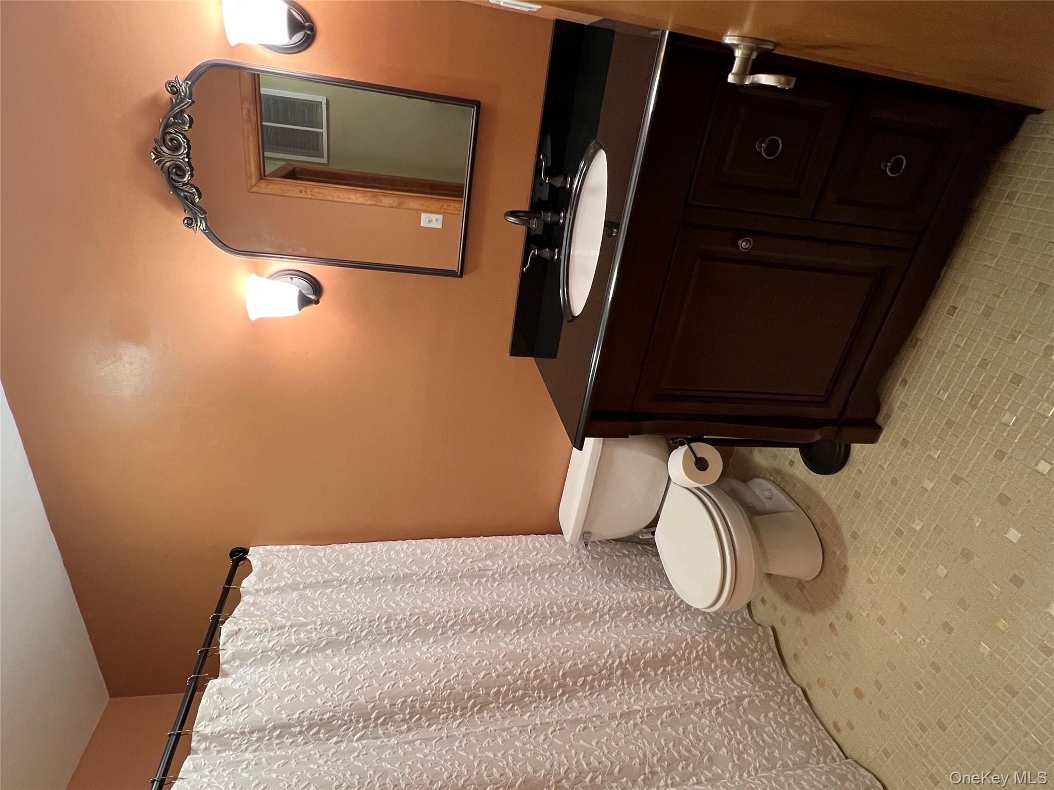 10 Squires Gate, Unit H Poughkeepsie, NY 12603 - Photo 16 of 24 a bathroom with a sink vanity mirror and toilet