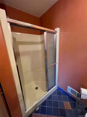 a bathroom with a glass door shower