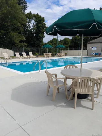 an outdoor space with furniture and umbrella