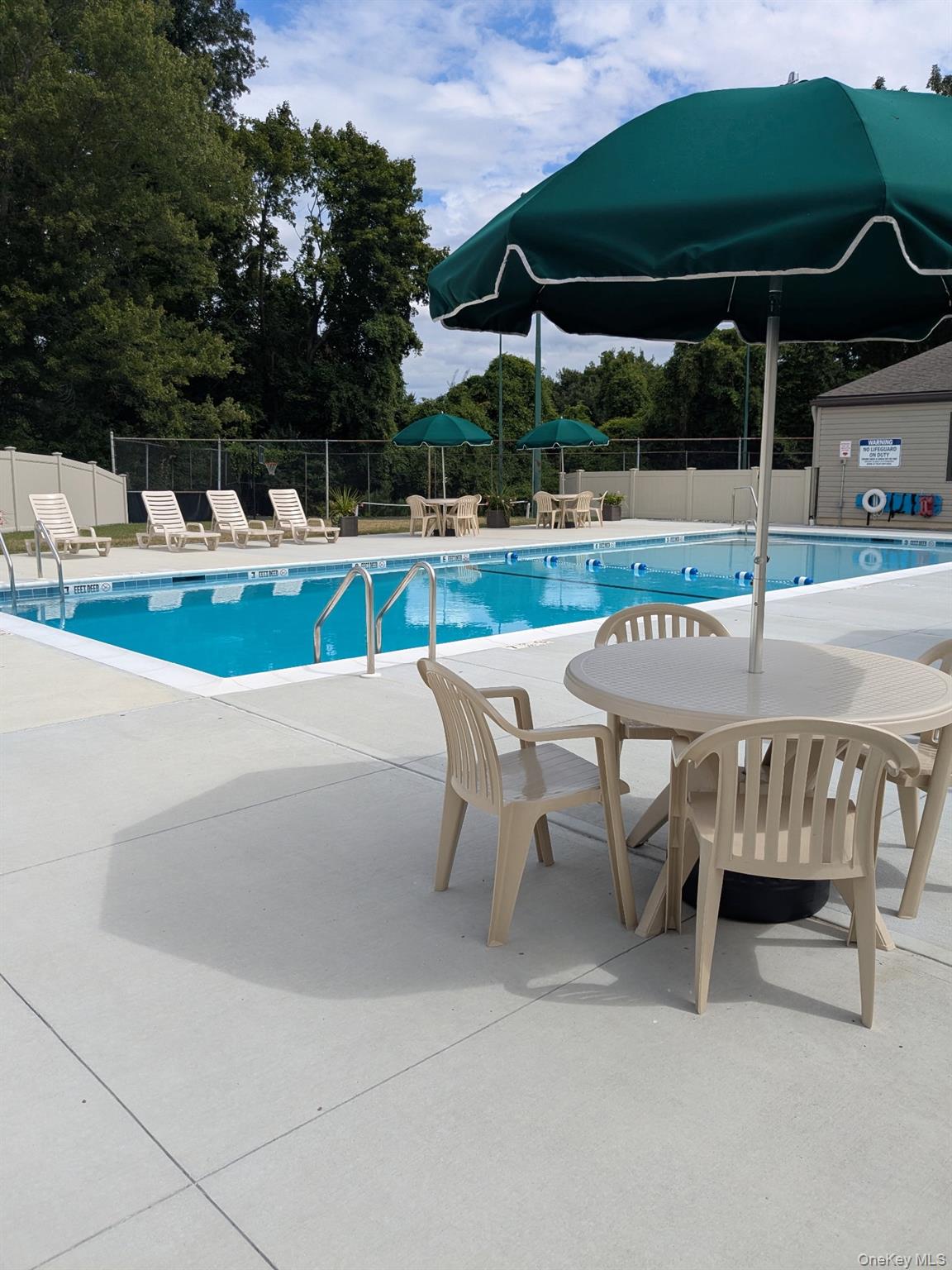 10 Squires Gate, Unit H Poughkeepsie, NY 12603 - Photo 22 of 24 an outdoor space with furniture and umbrella