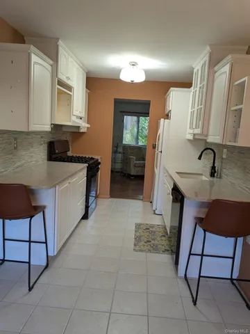 a kitchen with a sink and a stove top oven