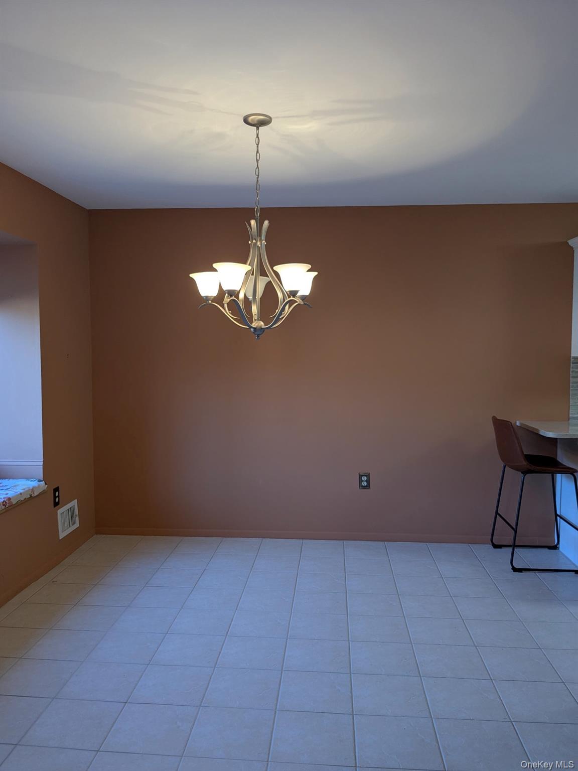 10 Squires Gate, Unit H Poughkeepsie, NY 12603 - Photo 5 of 24 a view of an empty room with a chandelier fan