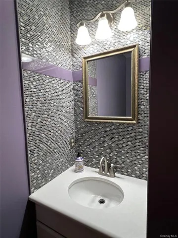 a bathroom with a sink and mirror