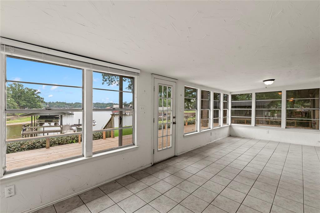 111 Deer Island Road Mabank, TX 75156 - Photo 16 of 26 Additional sunroom off the living room, wonderful for sitting and enjoying lake views year around.