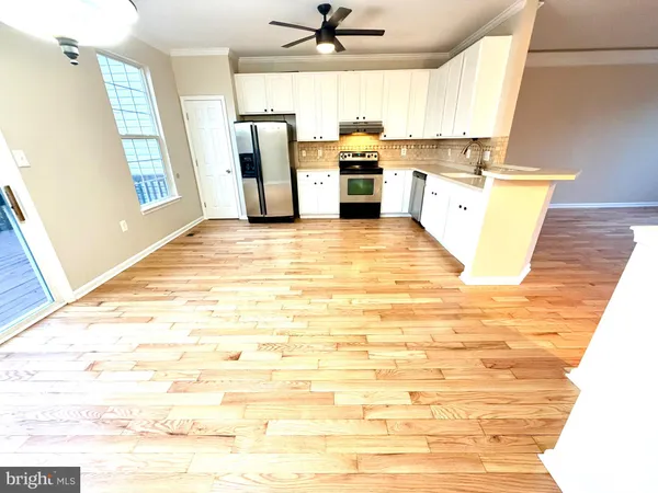 a view of a kitchen with a sink dishwasher stove and refrigerator