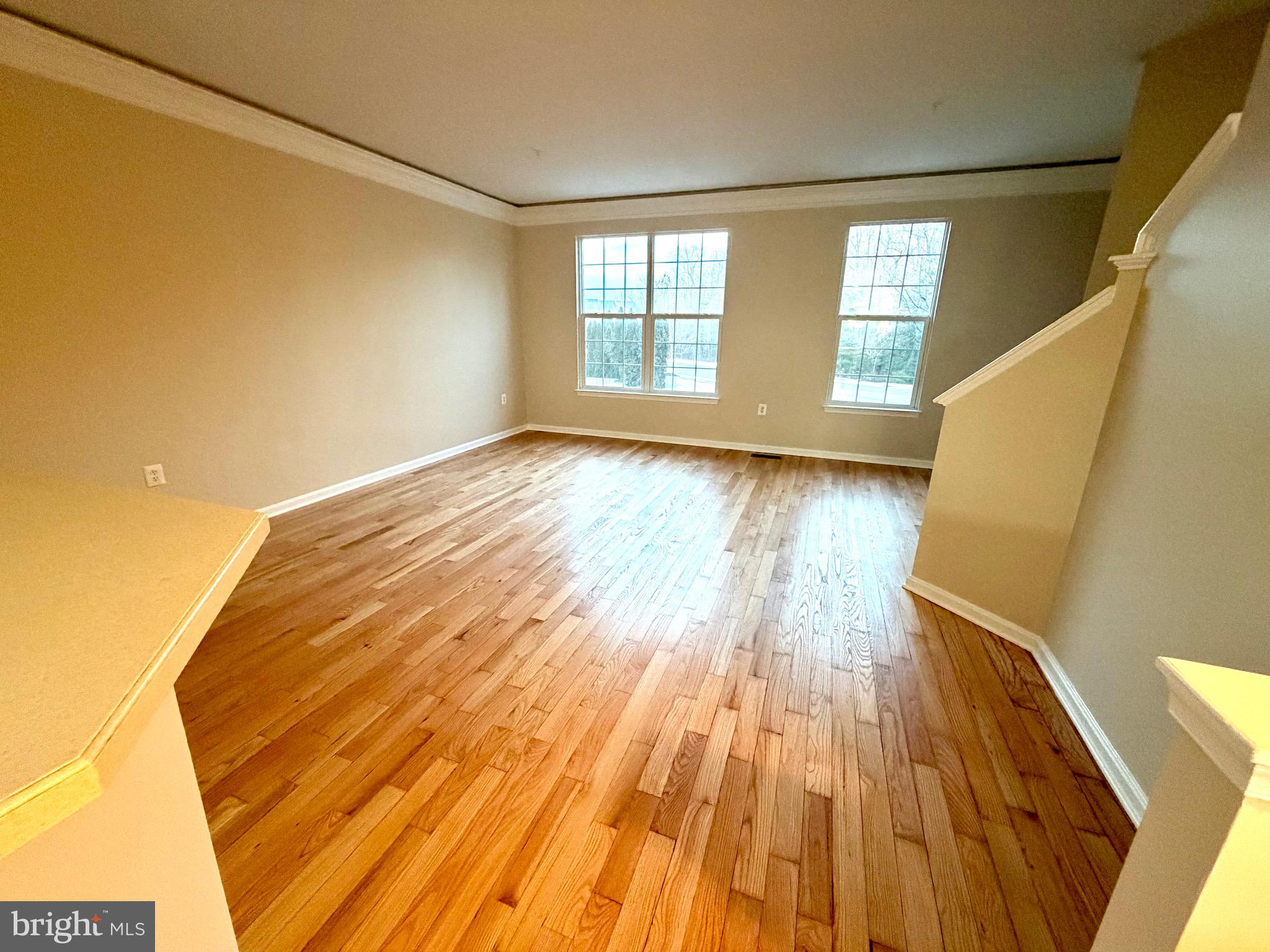 10158 Tree Frog Place White Plains, MD 20695 - Photo 15 of 25 a view of an empty room with wooden floor and a window