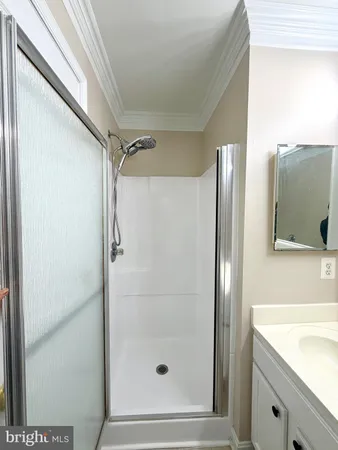 a bathroom with a shower and a sink