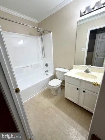 a bathroom with a sink a toilet and a large mirror
