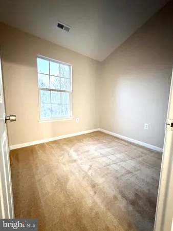 an empty room with a empty space and a window