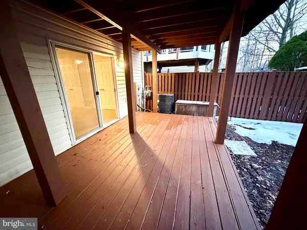 a view of backyard with wooden floor and outdoor seating