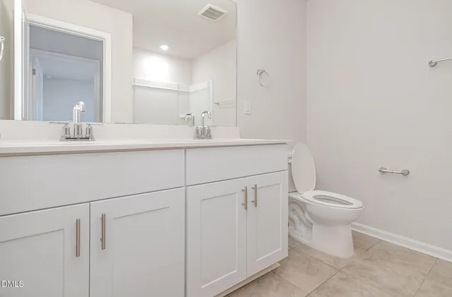 a bedroom with a bed and a night stand