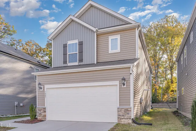 a view of a house with wooden fence