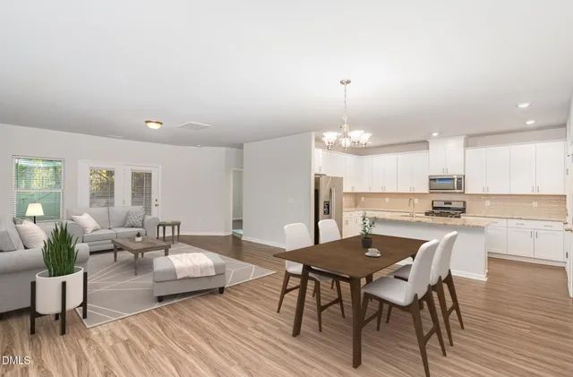 a view of a dining room with furniture wooden floor and chandelier