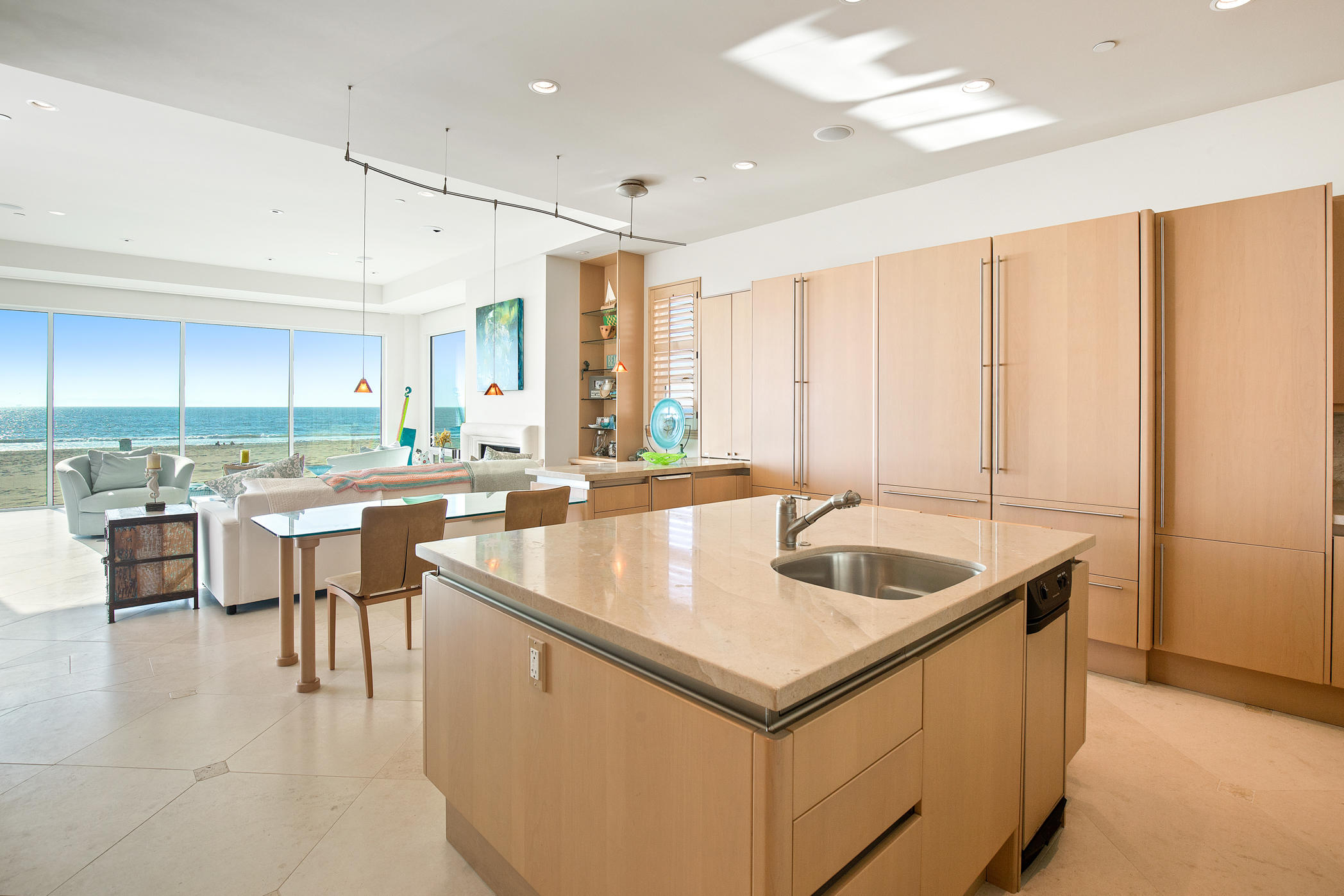 1135 Capri Way Oxnard, CA 93035 - Photo 15 of 50 a kitchen with kitchen island granite countertop a sink and white cabinets