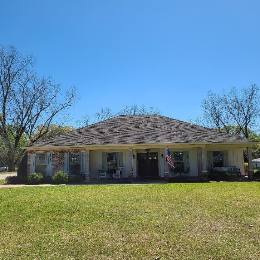 10051 Blackwell Nursery Road Semmes, AL 36575 - Photo 51 of 54 View of front of property featuring a porch, a front yard, a shingled roof, brick siding, and board and batten siding