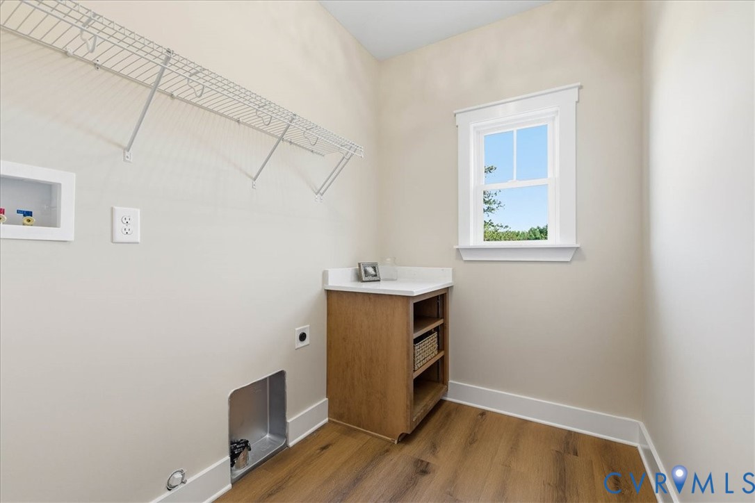 1602 Lansing Road Petersburg, VA 23805 - Photo 23 of 30 a view of an empty room with wooden floor and a window