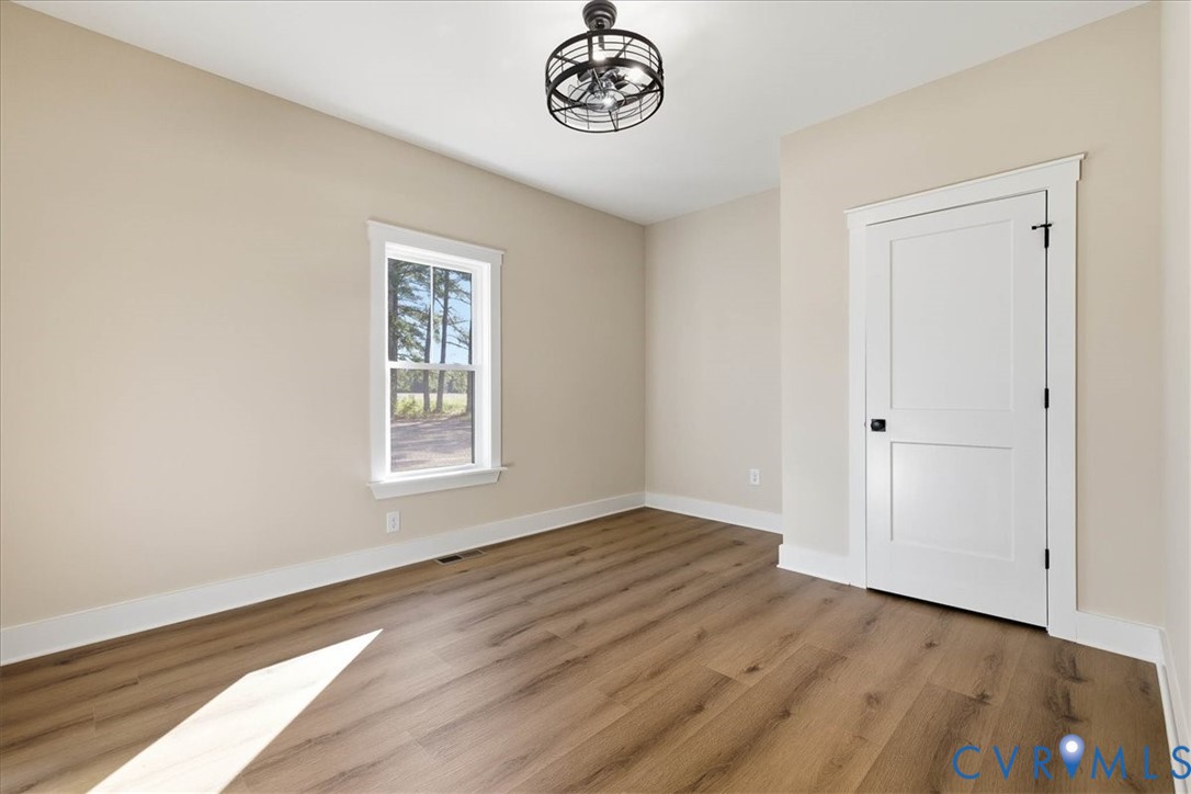 1602 Lansing Road Petersburg, VA 23805 - Photo 25 of 30 a view of an empty room with window and wooden floor