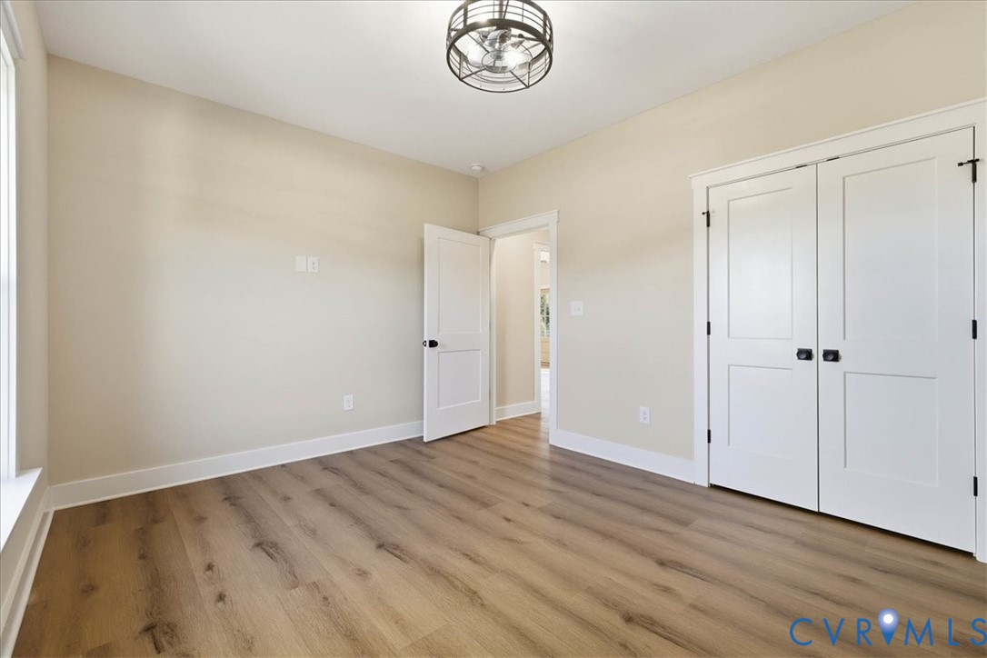 1602 Lansing Road Petersburg, VA 23805 - Photo 29 of 30 a view of an empty room with a window and wooden floor