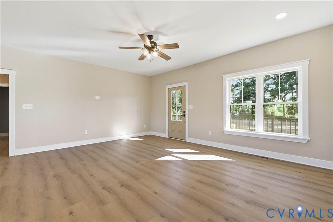 1602 Lansing Road Petersburg, VA 23805 - Photo 8 of 30 an empty room with wooden floor fan and windows