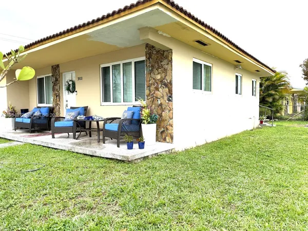 a view of a house with a backyard porch and sitting area