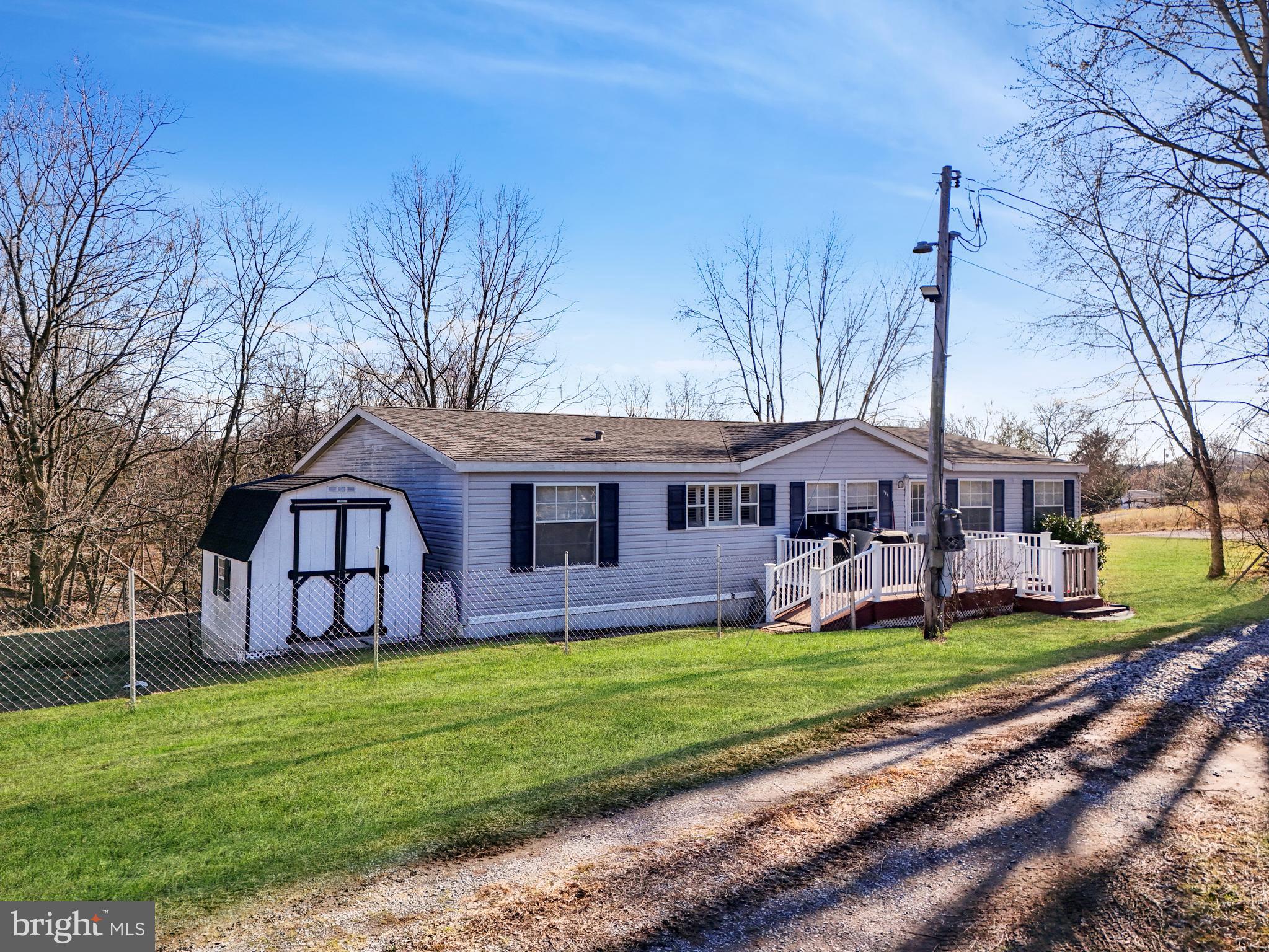 108 Rebel Drive Falling Waters, WV 25419 - Photo 2 of 27 a view of a house with a big yard and large tree