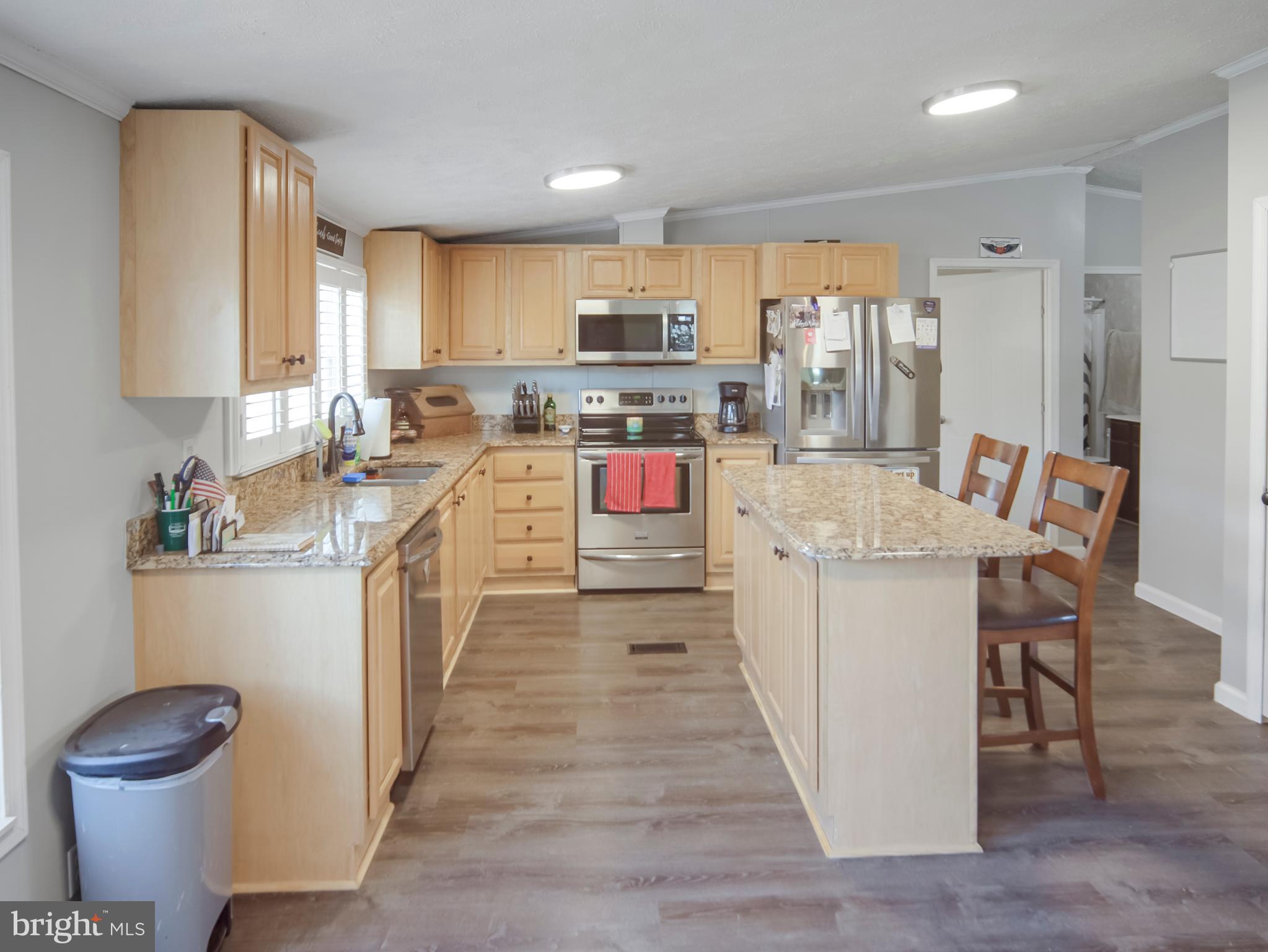 108 Rebel Drive Falling Waters, WV 25419 - Photo 21 of 27 a kitchen with a sink stove and wooden cabinets
