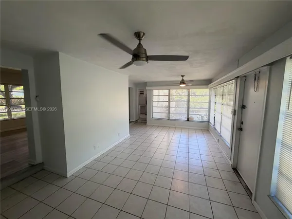 a kitchen with cabinets appliances a sink and a window