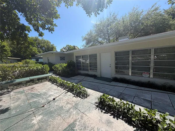 a house with trees in the background
