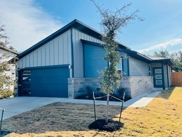 a house that has a tree in front of the house