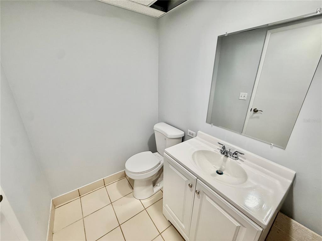 3760 Inverrary Drive, Unit 2M Lauderhill, FL 33319 - Photo 4 of 20 a bathroom with a sink toilet and vanity