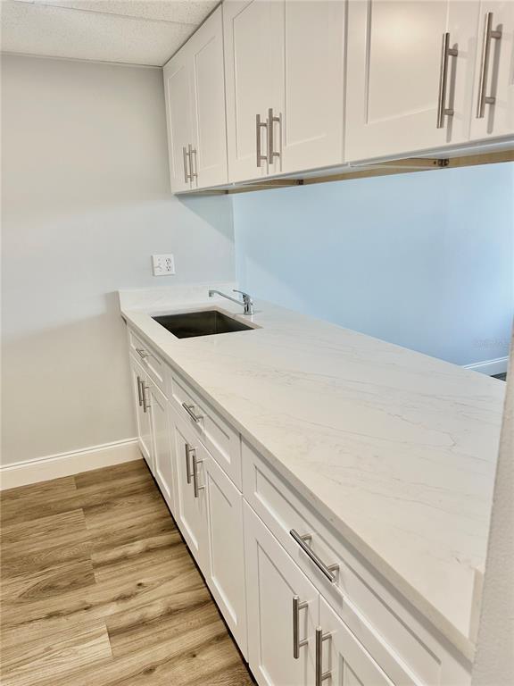 3760 Inverrary Drive, Unit 2M Lauderhill, FL 33319 - Photo 8 of 20 a kitchen with granite countertop white cabinets and white appliances