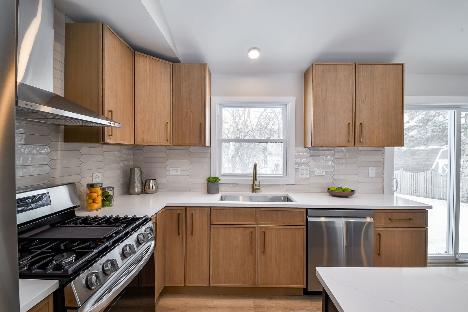 5740 Ridgewood Drive Western Springs, IL 60558 - Photo 14 of 25 a kitchen with stainless steel appliances a sink a stove a microwave cabinets and a window