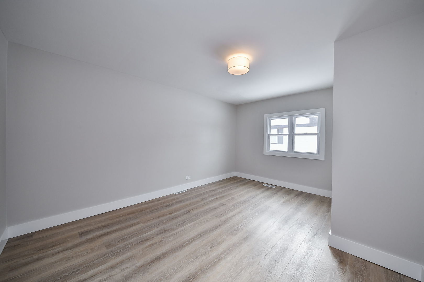 5740 Ridgewood Drive Western Springs, IL 60558 - Photo 19 of 25 an empty room with wooden floor and windows