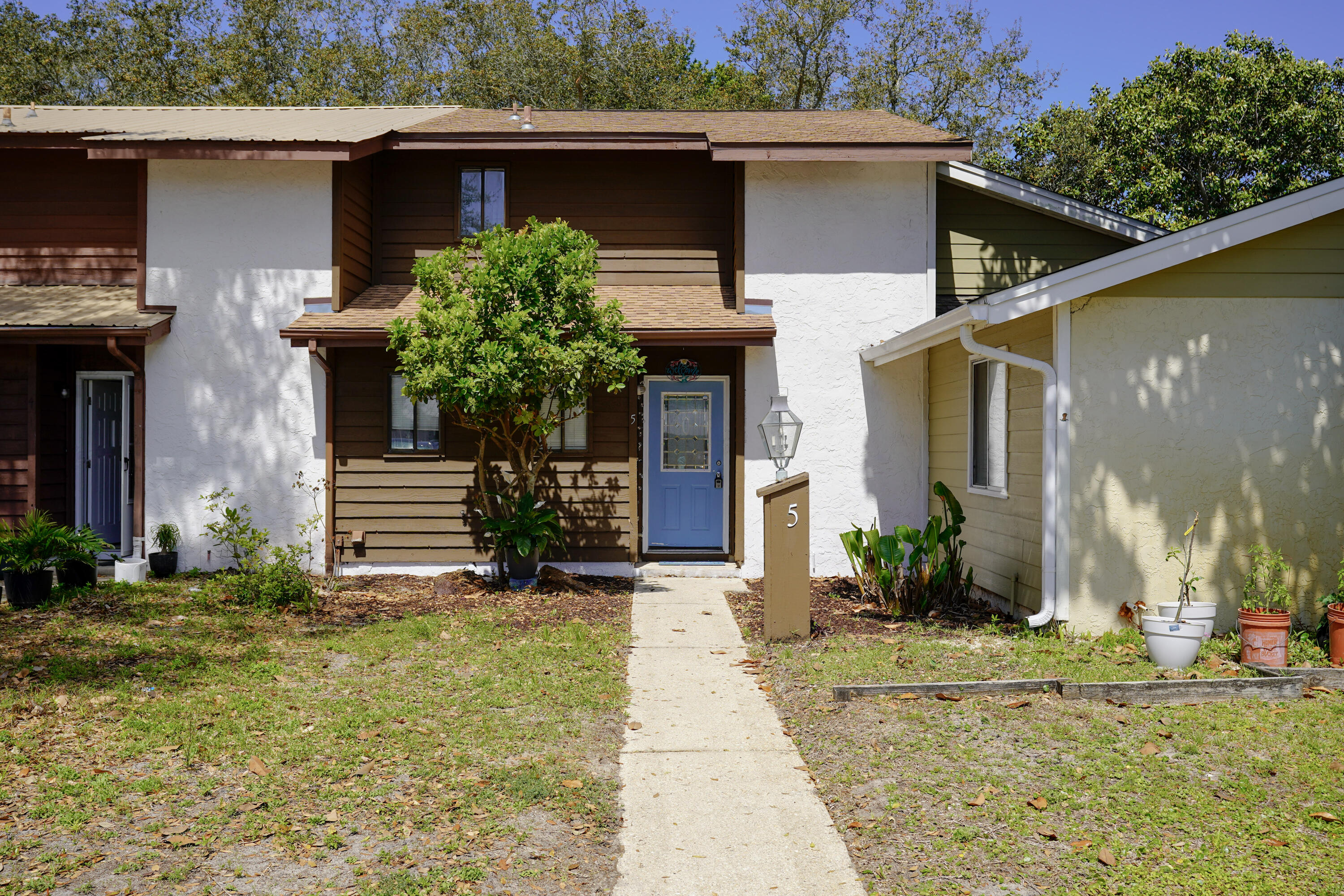 5 Pine Ridge Trace Destin, FL 32541 - Photo 2 of 22 a view of a house with a small yard plants and a large tree