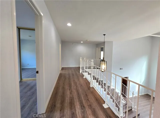 a view of entryway and hall with wooden floor