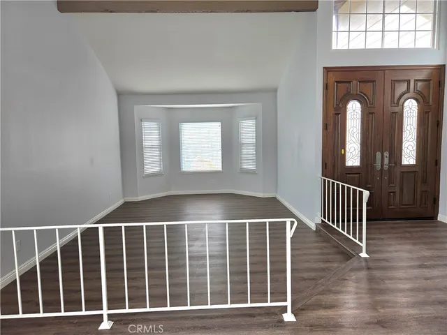 a view of an entryway with wooden floor and door