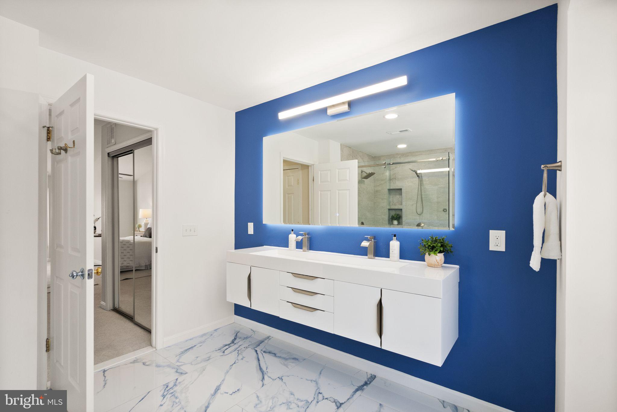 8144 Tall Timber Drive Gainesville, VA 20155 - Photo 37 of 73 a bathroom with a double vanity sink mirror and shower