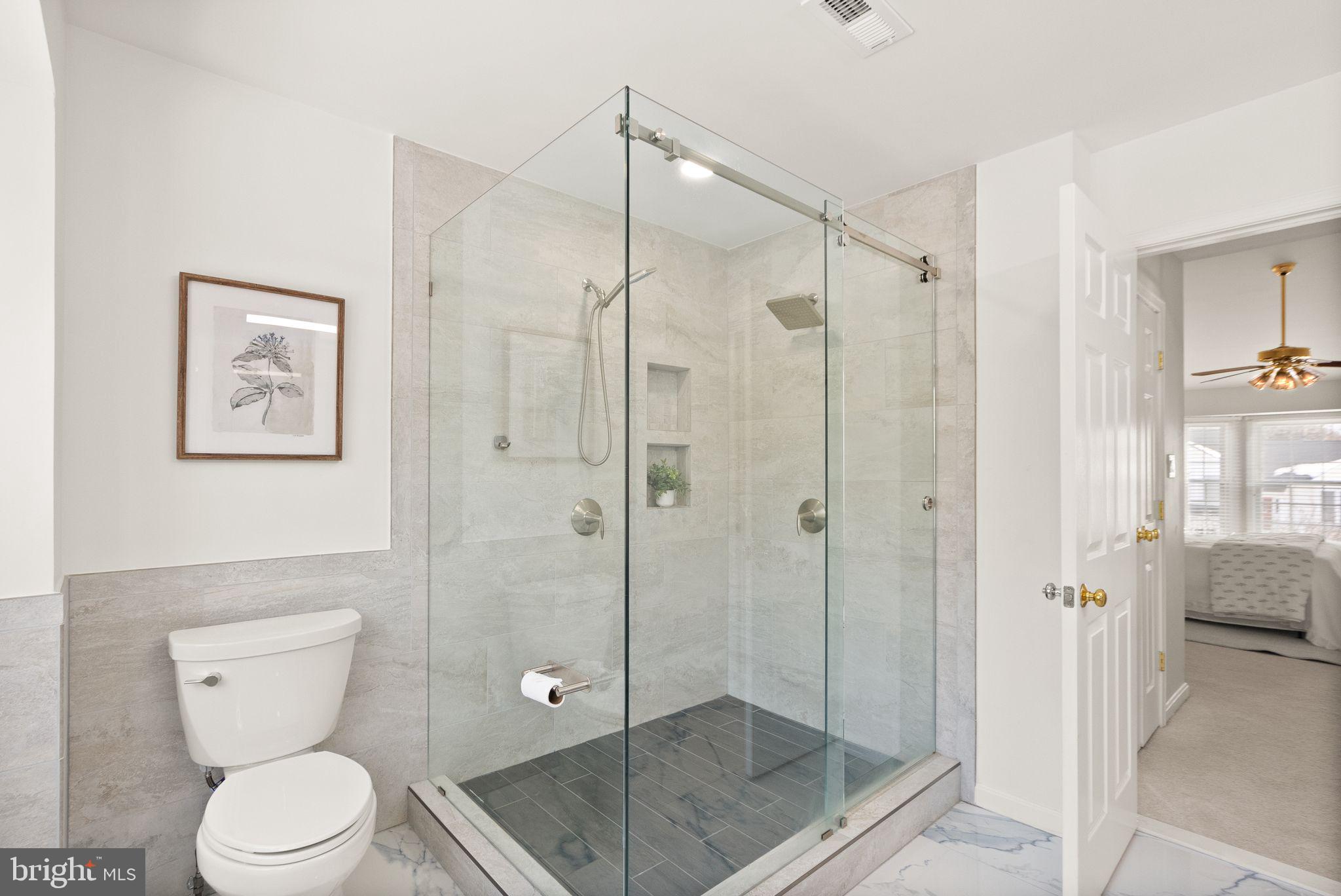 8144 Tall Timber Drive Gainesville, VA 20155 - Photo 38 of 73 a bathroom with a toilet a shower and a sink