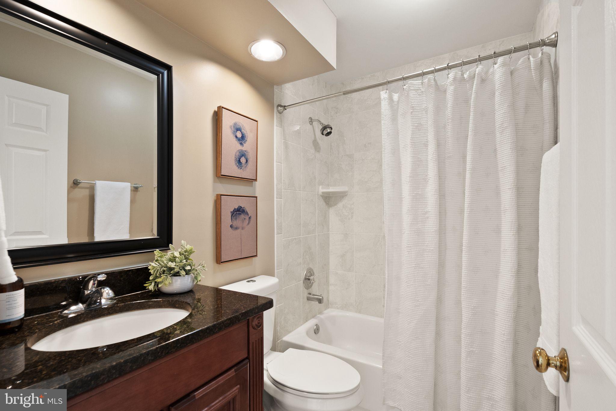 8144 Tall Timber Drive Gainesville, VA 20155 - Photo 44 of 73 a bathroom with a granite countertop sink toilet and shower