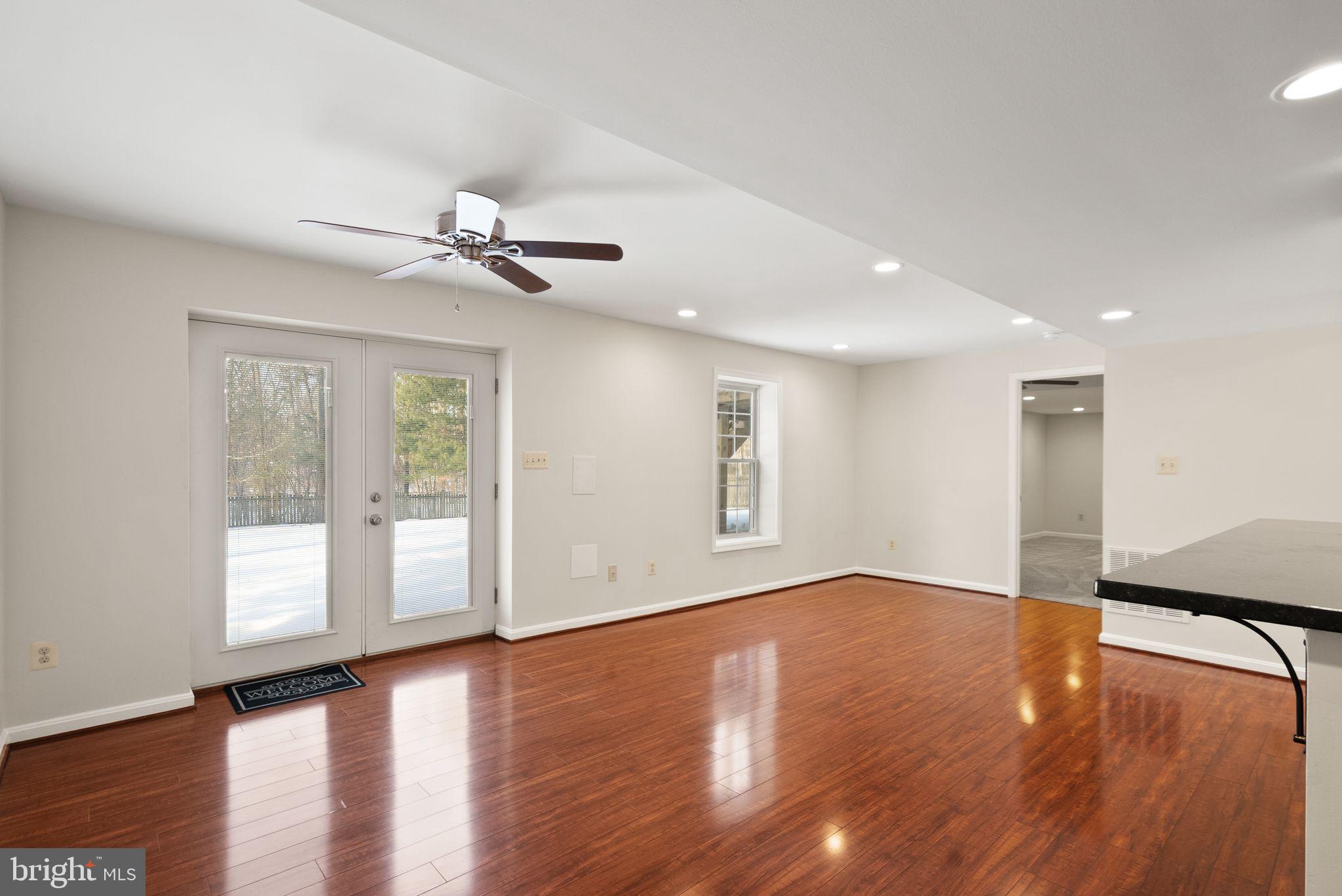8144 Tall Timber Drive Gainesville, VA 20155 - Photo 51 of 73 a view of an empty room with window and wooden floor