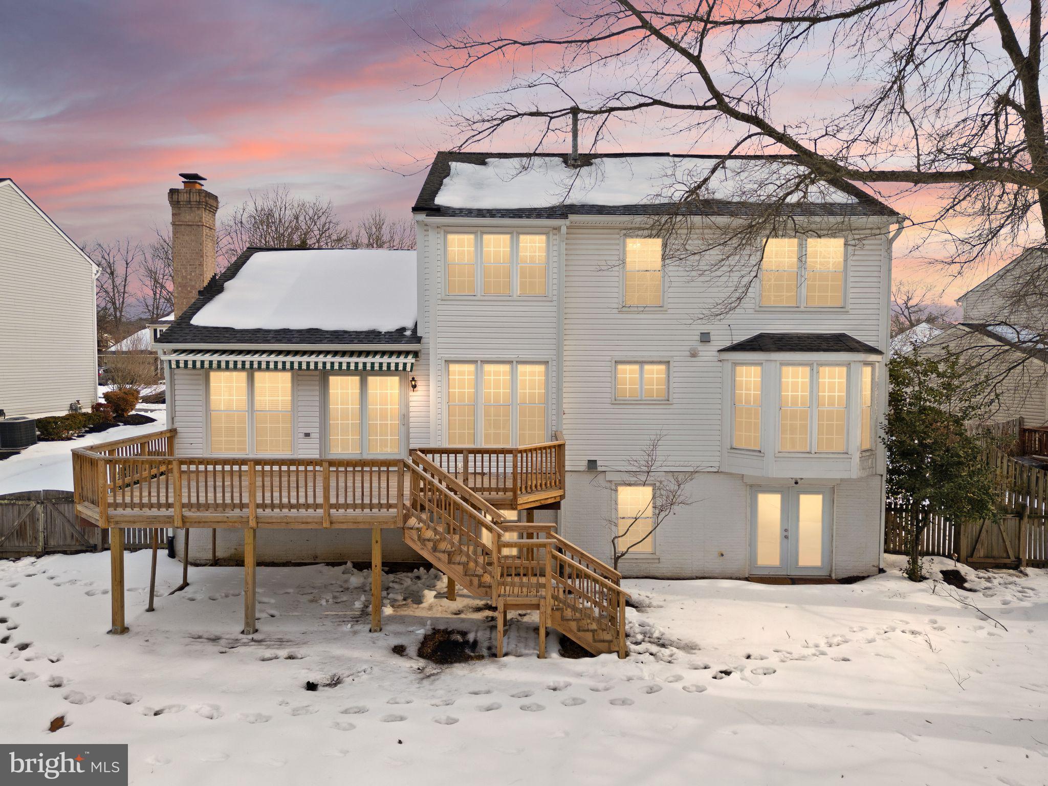 8144 Tall Timber Drive Gainesville, VA 20155 - Photo 65 of 73 a front view of a house with large trees and sitting space