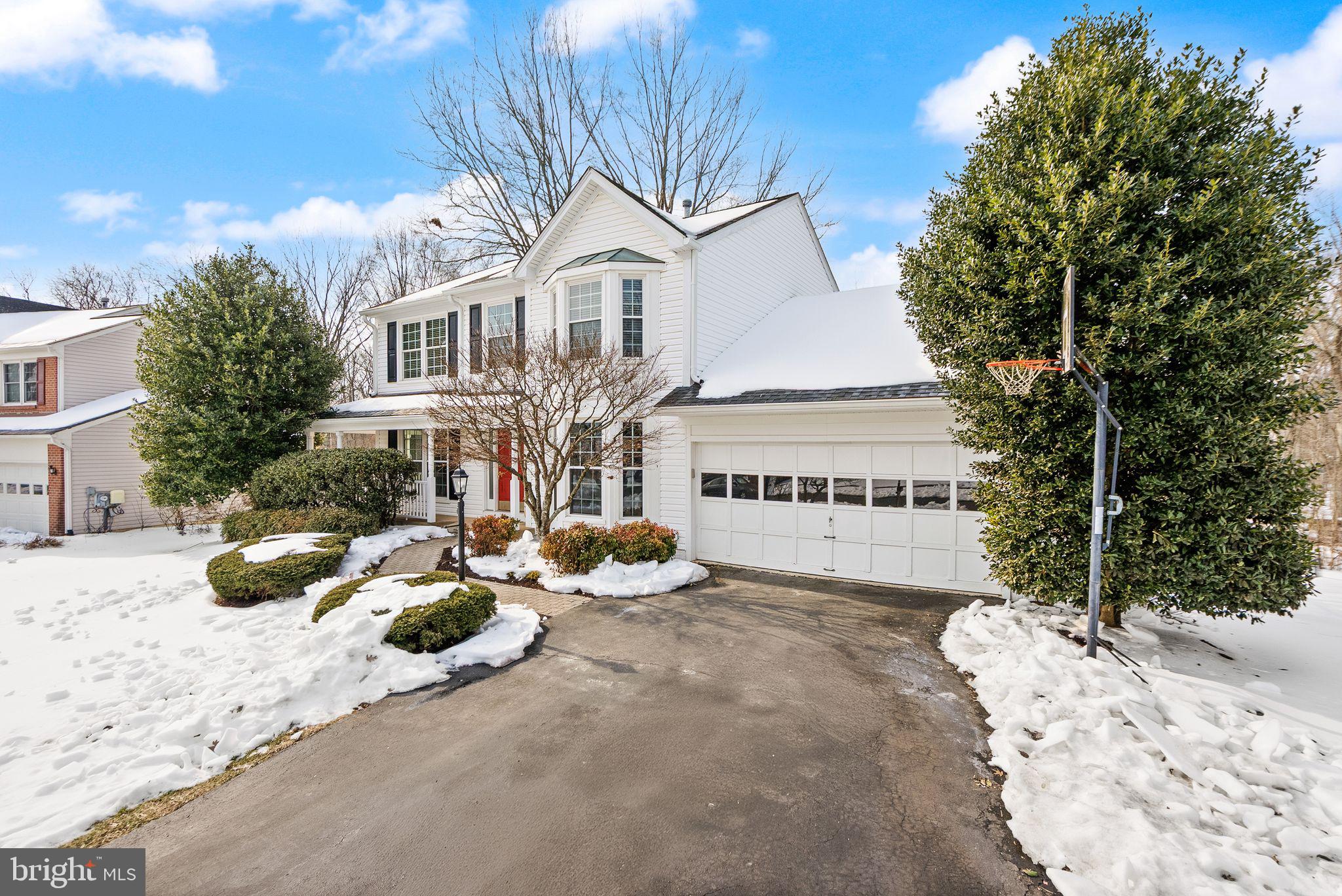 8144 Tall Timber Drive Gainesville, VA 20155 - Photo 9 of 73 a view of a white house with a yard covered with snow in the background