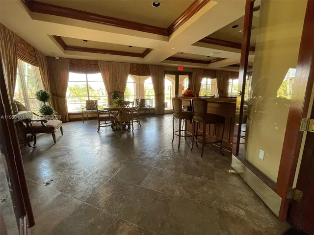 a lobby with furniture and a glass door